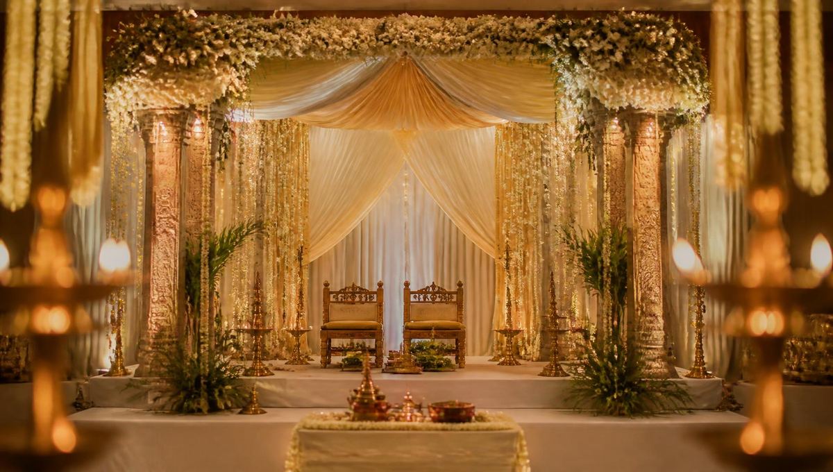 Elegant South Indian wedding mandapam decorated with jasmine flowers and brass lamps